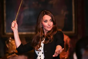 LONDON, ENGLAND - APRIL 26: Catherine, Duchess of Cambridge waves her wand on the set used to depict Diagon Alley in the Harry Potter Films during the Inauguration Of Warner Bros. Studios Leavesden on April 26, 2013 in London, England.  (Photo by Paul Rogers - WPA Pool/Getty Images)