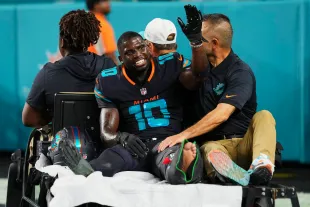 Tyreek Hill#10 of the Miami Dolphins is carted off the field after suffering an injury against the New York Jets during an NFL football game at Hard Rock Stadium on September 29, 2025 in Miami Gardens, Florida. (Photo by Cooper Neill/Getty Images)