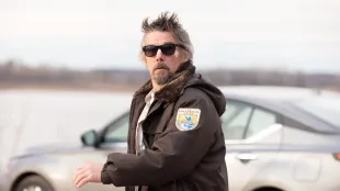 Lee Raybon (Ethan Hawke) in The Lowdown season 1 episode 3, wearing a borrowed Fish and Wildlife jacket by Keystone Lake. Photo credit: FX.