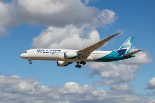 WestJet Airlines Boeing 787-9 Dreamliner passenger airplane as seen flying over the houses of Myrtle avenue, a famous plane spotting location, while landing at London Heathrow airport LHR. The modern and advanced wide body aircraft has the registration C-GURP and is powered by 2x GE jet engines. Westjet is a Canadian airline headquartered in Calgary, Alberta providing scheduled and charter air services, the second largest airline in Canada. London, United Kingdom on August 2022 (Photo by Nicolas Economou/NurPhoto via Getty Images)