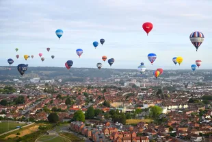 Hot Air balloons take to the sky during a mass ascent (Image via Getty)