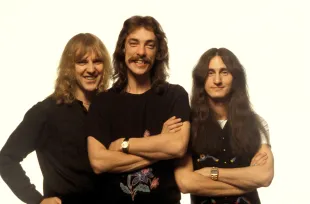 L-R: Alex Lifeson, Neil Peart, Geddy Lee - posed, studio, group shot  (Image via Getty)