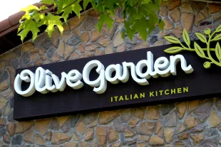 CHICAGO, ILLINOIS - JUNE 22: A sign hangs on the side of an Olive Garden restaurant on June 22, 2023 in Chicago, Illinois. Darden Restaurants, the parent company of Olive Garden, today reported quarterly earnings that topped Wall Street’s expectations, led by strong LongHorn Steakhouse sales. (Photo by Scott Olson/Getty Images)