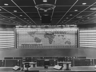 Interior view showing the control display system for Project Mercury, with an 8ft-by 26ft world map displaying the capsule's path in orbit and the locations of the remote tracking stations, in the Mercury Control Center (MCC) at the Cape Canaveral Space Force Station (CCSFS) on Cape Canaveral in Brevard County, Florida, 14th April 1961. Also known as Building 1385, the 50ft by 60ft operations room provided control and coordination of all activities associated with the NASA's Project Mercury flight operation as well as the first three Project Gemini flights. (Photo by Space Frontiers/Archive Photos/Getty Images)