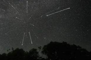 Stars are being seen in the sky during the Geminid meteor showers in Ratnapura, Sri Lanka, on December 14, 2023. The Geminids are a prolific meteor shower caused by the object 3200 Phaethon, which is thought to be a Palladian asteroid with a ''rock comet'' orbit. This makes the Geminids, together with the Quadrantids, the only major meteor showers not originating from a comet. (Photo by Thilina Kaluthotage/NurPhoto via Getty Images)