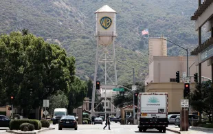 BURBANK, CALIFORNIA - SEPTEMBER 12: The Warner Bros. logo is displayed on a water tower at Warner Bros. Studio on September 12, 2025 in Burbank, California. Media giant Paramount Skydance is reportedly preparing a bid to purchase Warner Bros. Discovery, including its movie studio and cable networks. (Photo by Mario Tama/Getty Images)