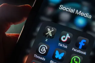 BATH, UNITED KINGDOM - JANUARY 07: In this photo illustration the logo of US online social media and social networking site 'X' (formerly known as Twitter) is displayed on a smartphone screen besides the logo of TikTok, Facebook and Threads on January 7, 2025 in Bath, England. The UK Prime Minister Sir Keir Starmer has recently hit back at Elon Musk who has been posting on his social media platform attacks on the Prime Minister and the Labour government. (Photo Illustration by Anna Barclay/Getty Images)