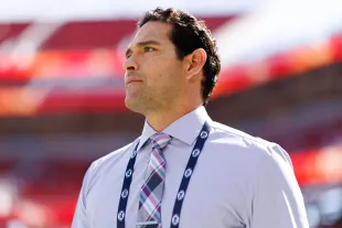 NFL broadcaster Mark Sanchez stands on the field prior to an NFL football game (Image via Getty)