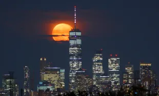 KEARNY, NJ - JULY 14: The Buck Moon or Thunder Moon rises behind lower Manhattan and One World Trade Center in New York City on July 14, 2022, as seen from Kearny, New Jersey. (Photo by Gary Hershorn/Getty Images)
