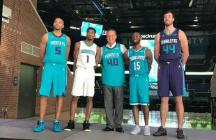 Doug Lebda posing with the Charlotte Hornets players in November 2017 (Image via X/DougLebda)