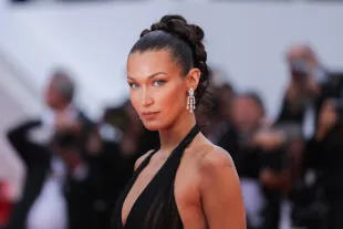 Bella Hadid attends the "L'Amour Ouf" (Beating Hearts) Red Carpet at the 77th annual Cannes Film Festival at Palais des Festivals (Image via Getty)