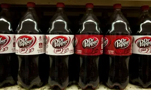Bottles of diet Dr Pepper and regular Dr Pepper soft drinks are displayed at a supermarket in the Brooklyn borough of New York, on Tuesday, July 26, 2011. The US annual soft drinks sales is approximately $66 billion. Coca-Cola Co., PepsiCo Inc., and Cadbury Schweppes Plc, control over 91% of the U.S. market share. (Photo by Ramin Talaie/Corbis via Getty Images)