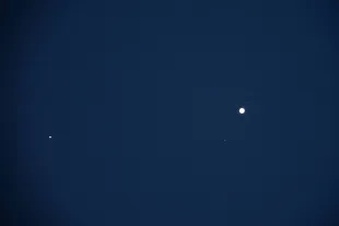 Planets Mars and Jupiter are seen in conjunction through a telescope in the sky above L'Aquila, Italy, on August 15th, 2024. Jupiter satellites, also known as Jupiter "Moons", are visible next to the planet. Mars and Jupiter met on the night between August 14 and 15 in the constellation of Taurus. The Gas Giant and the Red Planet created a spectacular close conjunction perfectly visible to the naked eye. (Photo by Lorenzo Di Cola/NurPhoto via Getty Images)