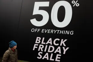 LONDON, ENGLAND - NOVEMBER 24: A woman walks past a Black Friday sale sign on Oxford Street on November 24, 2017 in London, England. British retailers offer deals on their products as part of the annual pre-Christmas Black Friday shopping event, held this year on November 24. (Photo by Jack Taylor/Getty Images)