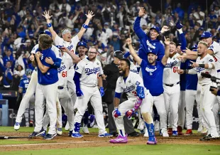 Los Angeles, CA - October 27:  Teammates wait for Freddie Freeman #5 of the Los Angeles Dodgers after he hit a walk off home run in the eighteenth inning to win game 3 of a World Series baseball game 6-5 against the Toronto Blue Jays at Dodger Stadium in Los Angeles on Monday, October 27, 2025. (Photo by Keith Birmingham/MediaNews Group/Pasadena Star-News via Getty Images)