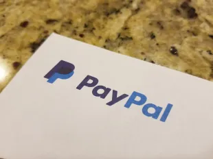 Close-up of logo for mobile payments company Paypal on paper, against a light wooden surface, April 21, 2019. (Photo by Smith Collection/Gado/Getty Images)
