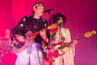 Win Butler and Regine Chassagne of Arcade Fire perform during the Don't Think About The Pink Elephant Tour at Saenger Theatre (Image via Getty)