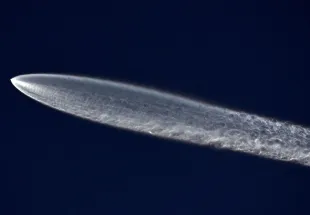 A SpaceX Falcon 9 rocket flies carrying a payload of 22 Starlink internet satellites into space after launching from Vandenberg Space Force Base on March 18, 2024 as seen from Los Angeles, California (Image via Getty)