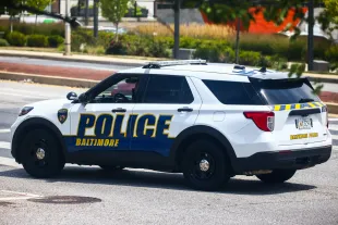 Baltimore Police Department suspends an officer for apparently trying to run down a civilian [Representational Image] (Image via Beata Zawrzel/NurPhoto/Getty Images)