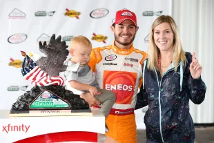 Kyle Larson, driver of the #42 Cessna/NTT Data Group Chevrolet, poses with Katelyn Sweet and son Owen (Image via Getty)