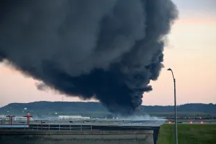 Fire and smoke mark where a UPS cargo plane crashed near Louisville Muhammad Ali International Airport on November 04, 2025 in Louisville, Kentucky. The fully fueled plane crashed shortly after takeoff with a shelter-in-place order issued for within 5 miles of the airport. (Photo by Stephen Cohen/Getty Images)