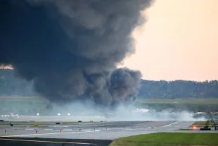 Fire and smoke mark where a UPS cargo plane crashed near Louisville Muhammad Ali International Airport on November 04, 2025 in Louisville, Kentucky. (Photo by Stephen Cohen/Getty Images)