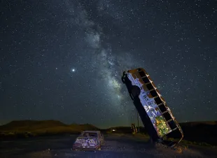 GOLDFIELD, NEVADA - JULY 18:  The Milky Way galaxy is seen from the International Car Forest of the Last Church on July 19, 2020 in Goldfield, Nevada. The Car Forest is an outdoor art installation of junk vehicles planted in the ground vertically.  (Photo by Ethan Miller/Getty Images)