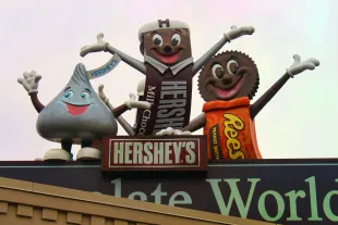 The Hershey characters standing on top of Hershey's Chocolate World, welcoming everyone to the sweetest place on earth! 