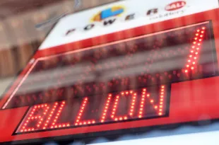 LOS ANGELES, CALIFORNIA - JULY 18: A California Lottery display shows projected winnings for the next Powerball drawing in a convenience store on July 18, 2023 in Los Angeles, California. The Powerball jackpot for the drawing on July 19th is now estimated to be $1 billion after three months of drawings without a winner. (Photo by Mario Tama/Getty Images)