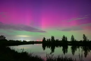 DALFSEN, NETHERLANDS - OCTOBER 10: Northern lights or aurora borealis In the night sky over the river Vecht in Overijssel, on October 10 in Dalfsen, The Netherlands. It is rare the Northern Lights can be spotted in The Netherlands but the aurora was even visible with the naked eye after a servere (G4) geomagnetic storm. (Photo by Sjoerd van der Wal/Getty Images)