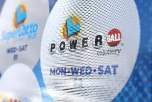 LOS ANGELES, CALIFORNIA - JULY 18: A California Lottery poster advertises Powerball and other lotteries at a convenience store on July 18, 2023 in Los Angeles, California. The Powerball jackpot for the drawing on July 19th is now estimated to be $1 billion after three months of drawings without a winner. (Photo by Mario Tama/Getty Images)