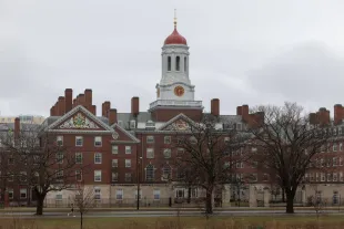 CAMBRIDGE, MASSACHUSETTS - MARCH 17: A person runs past Dunster House at Harvard University on March 17, 2025 in Cambridge, Massachusetts. Harvard University announced free tuition for students from families that make under $200K a year. (Photo by Scott Eisen/Getty Images)