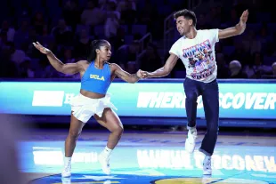 LOS ANGELES, CALIFORNIA - NOVEMBER 07: Jordan Chiles (L) and Ezra Sosa perform during halftime between the Pepperdine Waves and the UCLA Bruins at UCLA Pauley Pavilion on November 07, 2025 in Los Angeles, California. (Photo by Melina Pizano/Getty Images)