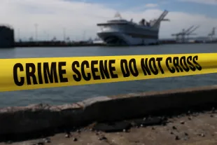 OAKLAND, CALIFORNIA - MARCH 10: Crime scene tape marks off the area where members of the media are staging near the Princess Cruises Grand Princess cruise ship as it sits docked in the Port of Oakland on March 10, 2020 in Oakland, California. Passengers are slowly disembarking from the Princess Cruises Grand Princess a day after it docked at the Port of Oakland. The ship was held off the coast of California after 21 people on board tested tested positive for COVID-19 also known as the Coronavirus. (Photo by Justin Sullivan/Getty Images)