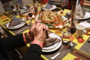 Central American immigrants and their families pray before Thanksgiving dinner on November 24, 2016 in Stamford, Connecticut (Image via Getty)