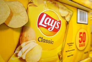 SAN DIEGO, CALIFORNIA - JULY 12: Boxes of Lay's classic potato chips are displayed at a Costco Wholesale store on July 12, 2025 in San Diego, California. (Photo by Kevin Carter/Getty Images)