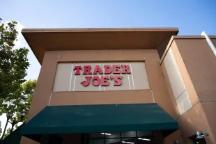 Trader Joe's supermarket exterior with red sign and green awning on a clear day, South San Francisco, California, October 16, 2025. (Photo by Smith Collection/Gado/Getty Images)