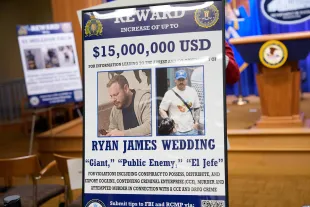 WASHINGTON, DC - NOVEMBER 19: A reward poster for the arrest of Ryan James Wedding is visible following a news conference announcing the indictment of a former Olympic snowboarder Ryan Wedding, charging him with murder and money laundering in connection to a drug trafficking organization at the Justice Department on November 19, 2025 in Washington, DC. The Justice Department announced a fifteen-million-dollar reward for information leading to the arrest of Ryan James Wedding, the leader of a criminal drug organization who smuggled large quantities of cocaine through Colombia and Mexico for distribution in the United States and Canada. (Photo by Andrew Harnik/Getty Images)