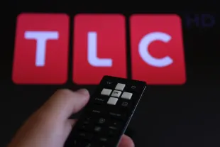 TLC logo displayed on a tv screen and a remote control are seen in this illustration photo taken in Poland on August 7, 2024. (Photo by Jakub Porzycki/NurPhoto via Getty Images)