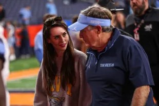 SYRACUSE, NEW YORK - OCTOBER 31: Jordan Hudson speaks with Bill Belichick of the North Carolina Tar Heels after a game against the Syracuse Orange at JMA Wireless Dome on October 31, 2025 in Syracuse, New York. (Photo by Bryan Bennett/Getty Images)