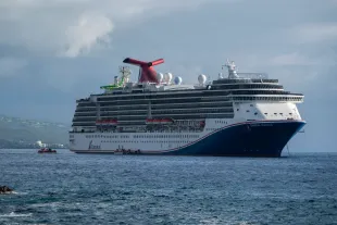 KAILUA-KONA, HAWAII- JANUARY 14: The Carnival Miracle cruise ship is anchored in the Pacific Ocean near Kailua Bay during a 15-day cruise on January 14, 2024 in Kailua-Kona, Hawaii.  (Photo by Kevin Carter/Getty Images)