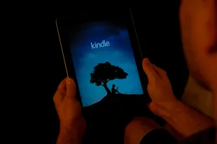 A man is seen using the Amazon Kindle application on an iPad on November 2, 2017. (Photo by Jaap Arriens/NurPhoto via Getty Images)