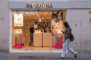 PALMA DE MALLORCA, SPAIN - APRIL 19: A woman walks past a Pandora jewellery retail store on the Carrer de Sant Miquel on April 19, 2024 in Palma de Mallorca, Spain. (Photo by John Keeble/Getty Images)