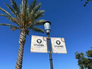 Signs for Crumbl cookies beside a palm tree at Veranda shopping center in Concord, California, July 19, 2022. Photo courtesy Sftm. (Photo by Gado/Getty Images)