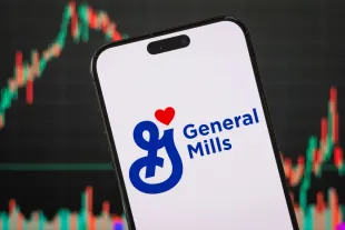 CHONGQING, CHINA - MARCH 16: In this photo illustration, the General Mills logo is displayed on a smartphone screen, with the company's latest stock market performance and candlestick charts visible in the background, highlighting General Mills' real-time financial trends, stock price fluctuations, market volatility, and investment developments within the food and consumer goods industry, on March 16, 2025, in Chongqing, China. (Photo by Cheng Xin/Getty Images)
