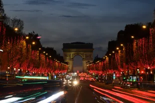 PARIS, FRANCE - NOVEMBER 24: Red lights decorate the trees to illuminate the Champs-Elysees avenue with the Arc de Triomphe in the background for Christmas and New Year celebrations on November 24, 2020 in Paris, France. (Photo by Pascal Le Segretain/Getty Images)