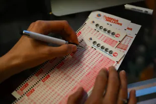 CALIFORNIA, USA - JULY 18: A person plays lottery at a store as US Powerball jackpot grand prize grew to a whopping $1 billion after no ticket got all six numbers in San Mateo, California, United States on July 18, 2023. (Photo by Tayfun Coskun/Anadolu Agency via Getty Images)