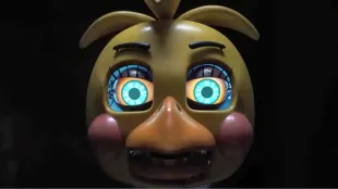 Toy Chica close up from Five Nights at Freddy’s 2, a trailer still that hints at the Marionette’s hold. Image via Universal Pictures