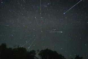 Stars are being seen in the sky during the Geminid meteor showers in Ratnapura, Sri Lanka, on December 14, 2023. The Geminids are a prolific meteor shower caused by the object 3200 Phaethon, which is thought to be a Palladian asteroid with a ''rock comet'' orbit. This makes the Geminids, together with the Quadrantids, the only major meteor showers not originating from a comet. (Photo by Thilina Kaluthotage/NurPhoto via Getty Images)