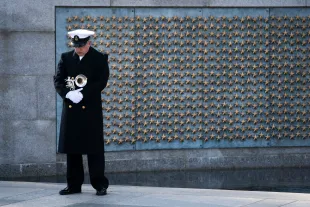 WASHINGTON, DC - DECEMBER 07: A trumpeter with a military honor guard pauses at the World War II Memorial during a wreath-laying ceremony to mark National Pearl Harbor Remembrance Day on December 7, 2020 in Washington, DC. On Dec. 7th, 1941, more than 2,400 Americans lost their lives in the surprise attack on a U.S. Naval station at Pearl Harbor by the Imperial Japanese Navy Air Service. The attack was the catalyst for the United States' entry into World War II. (Photo by Drew Angerer/Getty Images)